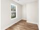 Empty room with hardwood floors and a window with natural light at 8160 Stone Hill Rd, Cumming, GA 30028