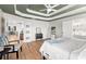 Spacious bedroom with hardwood floors, elegant trim, and ensuite bath access at 8160 Stone Hill Rd, Cumming, GA 30028