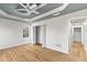Spacious bedroom with hardwood floors and a tray ceiling at 8160 Stone Hill Rd, Cumming, GA 30028
