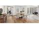 Dining area features hardwood floors, natural lighting, and a view of the sunroom and access to the outdoor deck at 8160 Stone Hill Rd, Cumming, GA 30028