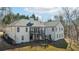 Expansive back exterior featuring a spacious deck with stairs, complemented by neutral siding and multiple windows at 8160 Stone Hill Rd, Cumming, GA 30028