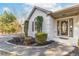 Charming front entrance with well-manicured landscaping, complemented by a decorative glass front door at 8160 Stone Hill Rd, Cumming, GA 30028