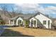 Attractive single-story home with well-maintained yard and attached three-car garage at 8160 Stone Hill Rd, Cumming, GA 30028