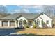 Inviting exterior showcasing a brick home with a well-maintained lawn, elegant windows and a three car garage at 8160 Stone Hill Rd, Cumming, GA 30028