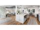 This eat-in kitchen features a large island, stainless steel appliances, and an open view to the Gathering room at 8160 Stone Hill Rd, Cumming, GA 30028