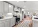 Bright kitchen features white cabinets, stainless steel appliances, marble countertops, and mosaic tile backsplash at 8160 Stone Hill Rd, Cumming, GA 30028