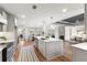 Bright, open kitchen with a center island, stainless steel appliances, and hardwood flooring at 8160 Stone Hill Rd, Cumming, GA 30028
