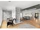 Cozy living room featuring a stone accent wall, tray ceilings, hardwood floors, and lots of natural light at 8160 Stone Hill Rd, Cumming, GA 30028