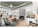 Cozy living room with a stone fireplace, hardwood flooring, and access to the deck at 8160 Stone Hill Rd, Cumming, GA 30028