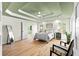 Spacious main bedroom with tray ceilings, hardwood floors, lots of natural light, and an en suite bathroom at 8160 Stone Hill Rd, Cumming, GA 30028