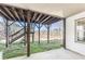 Covered patio with wooden support columns and steps to the backyard at 8160 Stone Hill Rd, Cumming, GA 30028