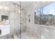 Bright shower features stylish tile, glass doors, and a large window with a view at 8160 Stone Hill Rd, Cumming, GA 30028