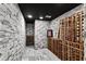 Wine cellar with stone walls, tile floors, and wooden wine racks, offering a sophisticated storage solution at 8160 Stone Hill Rd, Cumming, GA 30028