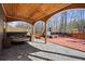 Backyard with a patio that features a round couch with an adjacent hot tub surrounded by many trees at 1617 Matt Springs Dr, Lawrenceville, GA 30045