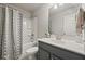 Well-lit bathroom featuring modern fixtures, a shower-tub combo, and neutral decor at 1617 Matt Springs Dr, Lawrenceville, GA 30045