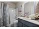 Bathroom with tub shower, gray vanity, and modern decor at 1617 Matt Springs Dr, Lawrenceville, GA 30045