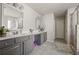 Bathroom featuring double sinks, generous counter space, and a tiled walk-in shower at 1617 Matt Springs Dr, Lawrenceville, GA 30045
