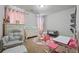 Cozy ' bedroom featuring playful decor, a comfortable rocking chair, and ample space at 1617 Matt Springs Dr, Lawrenceville, GA 30045