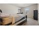 Bright bedroom with neutral walls, a simple bed frame, and a view of the outdoors through a window at 1617 Matt Springs Dr, Lawrenceville, GA 30045