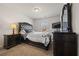 Tastefully designed bedroom featuring a dark wooden bed frame and well-matched furniture at 1617 Matt Springs Dr, Lawrenceville, GA 30045