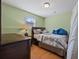 Comfortable bedroom with window, wooden furniture, warm lamp, and carpet, offering cozy retreat at 1617 Matt Springs Dr, Lawrenceville, GA 30045