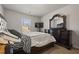 Comfortable bedroom featuring a large bed, decorative pillows, and a classic wood dresser with a mirror at 1617 Matt Springs Dr, Lawrenceville, GA 30045
