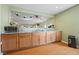 Open kitchen features wood cabinets, granite countertops, stainless steel microwave, and wood-style flooring at 1617 Matt Springs Dr, Lawrenceville, GA 30045