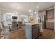 Open concept kitchen with island, stainless appliances, and adjacent dining area at 1617 Matt Springs Dr, Lawrenceville, GA 30045