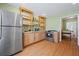 Open kitchen with stainless steel appliances, ample wood cabinets, granite countertops, and a wood-style floor at 1617 Matt Springs Dr, Lawrenceville, GA 30045