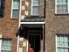 Classic brick townhouse facade showcasing the front door, complemented by well-placed windows and architectural details at 2372 Johnson Rd, Atlanta, GA 30345