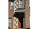 Inviting brick townhouse exterior featuring a red front door with decorative awning and multiple windows at 2372 Johnson Rd, Atlanta, GA 30345