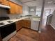 Traditional kitchen equipped with wood cabinets, white appliances, and laminate countertops at 2372 Johnson Rd, Atlanta, GA 30345