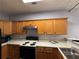 Efficient kitchen with wooden cabinetry, white countertops, and modern appliances at 2372 Johnson Rd, Atlanta, GA 30345
