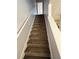 Carpeted staircase with white painted walls and railings leads to the upper level at 2372 Johnson Rd, Atlanta, GA 30345