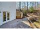 Back patio with a paver pathway, offering a peaceful retreat surrounded by nature at 2418 Caylor Hill Pte Nw, Kennesaw, GA 30152