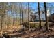 Spacious backyard with a firepit, deck, and lush tree setting at 2418 Caylor Hill Pte Nw, Kennesaw, GA 30152