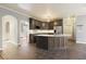 Modern kitchen featuring gray cabinets, a center island with a white countertop, and gray tile flooring at 2418 Caylor Hill Pte Nw, Kennesaw, GA 30152