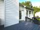 Back deck with white siding, dark railings, and a door leading inside, creating an inviting outdoor space at 53 Carrington Lndg, Douglasville, GA 30134