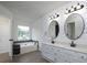 Bathroom with double vanity, two mirrors, and a bathtub at 53 Carrington Lndg, Douglasville, GA 30134