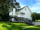 Exterior of home boasts an impressive deck with stairs and a ramp, complemented by a well-maintained lawn at 53 Carrington Lndg, Douglasville, GA 30134
