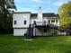 Rear view shows exterior of home features deck with stairs, siding, and well-kept lawn, blending with the surrounding nature at 53 Carrington Lndg, Douglasville, GA 30134