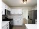 The modern kitchen offers white cabinets, quartz countertops, and stainless steel appliances at 53 Carrington Lndg, Douglasville, GA 30134