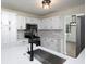 Modern kitchen features white cabinets, quartz countertops, stainless steel appliances, and a large sink at 53 Carrington Lndg, Douglasville, GA 30134