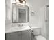 Bathroom featuring vanity, toilet, and shower with white tile at 5539 Andrew Sw Dr, Mableton, GA 30126