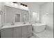 Modern bathroom with double vanity, soaking tub, and marble tile at 5539 Andrew Sw Dr, Mableton, GA 30126