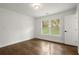 Bright bedroom with hardwood floors, windows, and a white door at 5539 Andrew Sw Dr, Mableton, GA 30126