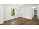 Minimalist dining area featuring hardwood floors, chandelier, and large windows at 5539 Andrew Sw Dr, Mableton, GA 30126