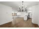 Open-concept space with kitchen island, stainless appliances, and hardwood floors at 5539 Andrew Sw Dr, Mableton, GA 30126
