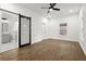Bright main bedroom featuring hardwood floors, a ceiling fan, and an en-suite bathroom at 5539 Andrew Sw Dr, Mableton, GA 30126