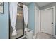 Bathroom with a glass-enclosed shower featuring white curtains and a modern tile design at 8340 Nolandwood Ln, Villa Rica, GA 30180